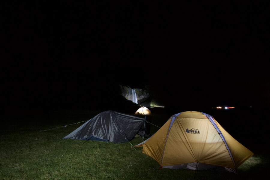 Hamragarðar Campground at night with the waterfall lit up